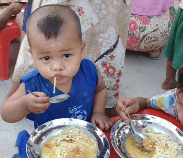 Young children eating ready made meal