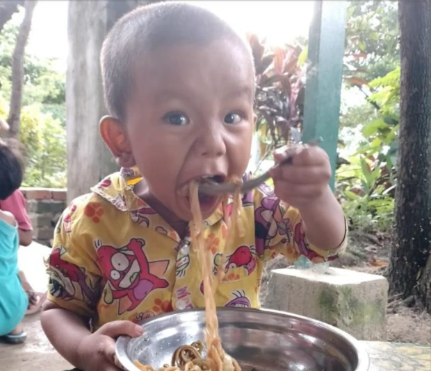Young child eating ready made meal