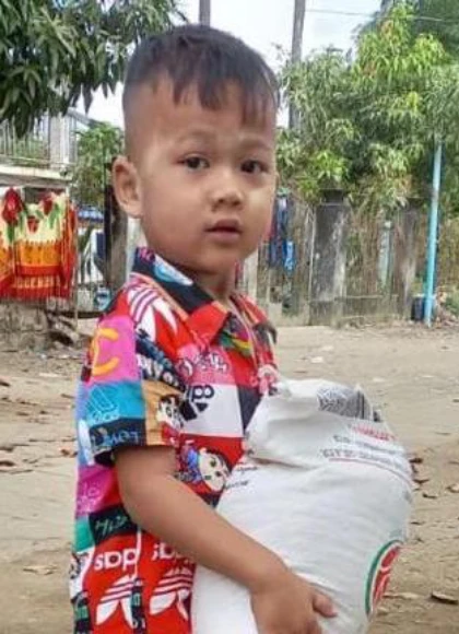 young boy receiving relief packet
