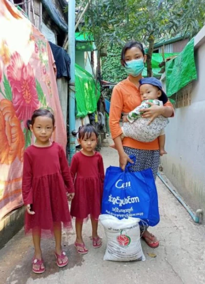 Family holding humanitarian relief kits