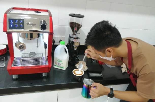SISU trainee making coffee art