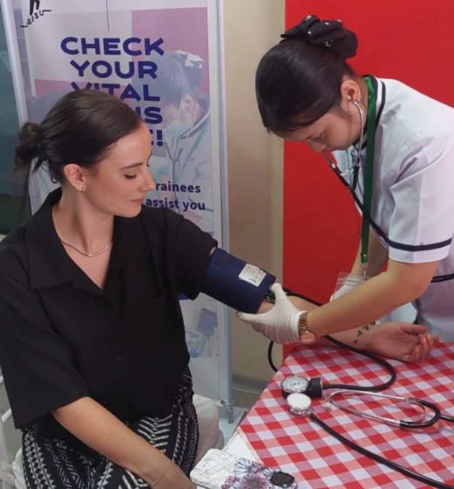 SISU health care trainee checking patient vitals