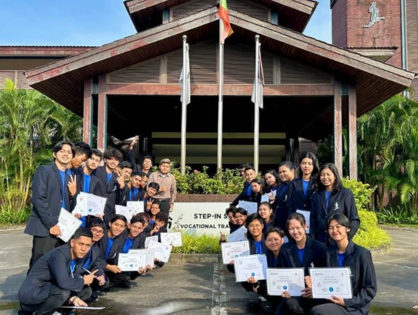 SISU TOT graduates holding certificates in front of SISU training centre