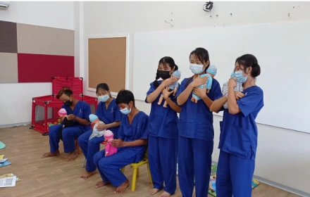 SISU trainees learning infant care