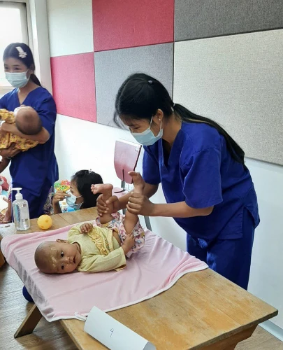 SISU trainees learning baby and child care on table