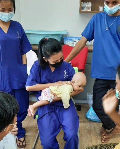 SISU trainees learning baby and child care techniques