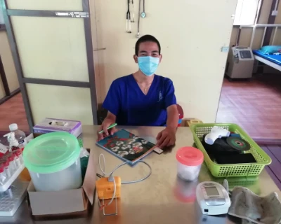 SISU basic health care trainee behind desk at internship