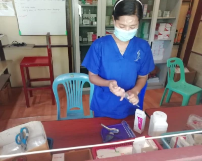 SISU basic health care trainee behind medicine table at internship