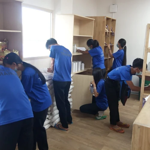 SISU trainees learning about stocking shelves and inventory management