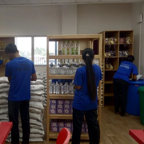 SISU trainees learning about stocking shelves and inventory management