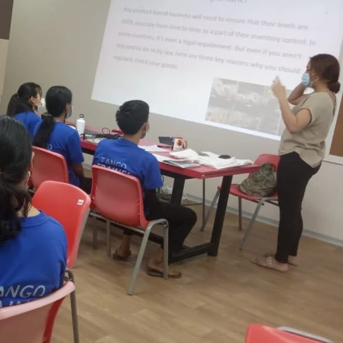 SISU trainees learning about stocking shelves and inventory management in classroom