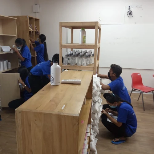 SISU trainees learning about stocking shelves and inventory management