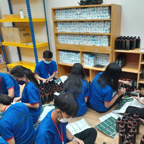 SISU trainees learning about stocking shelves and inventory management